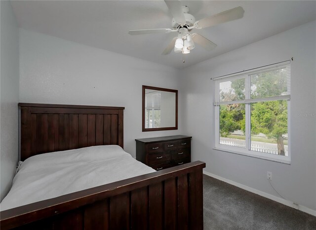 bedroom featuring ceiling fan and dark colored carpet