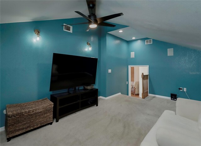 living room featuring carpet flooring, vaulted ceiling, and ceiling fan