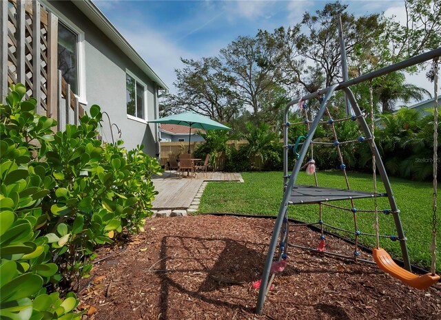 view of yard with a playground and a patio area