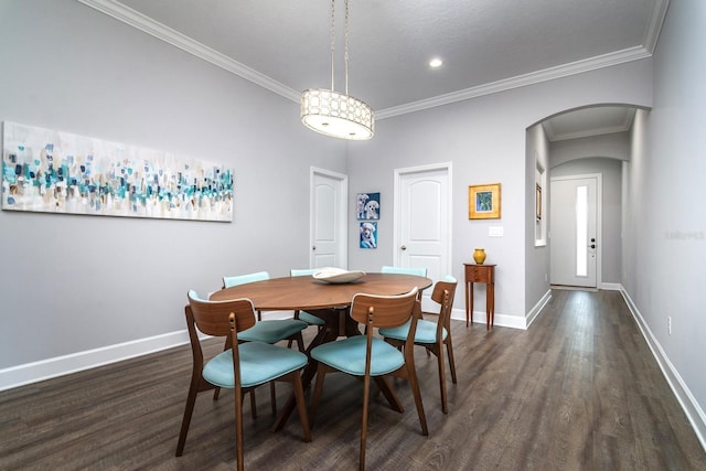 dining space featuring ornamental molding and dark wood-type flooring