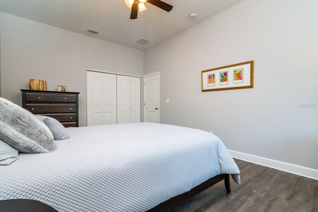 bedroom featuring dark hardwood / wood-style flooring, a closet, and ceiling fan