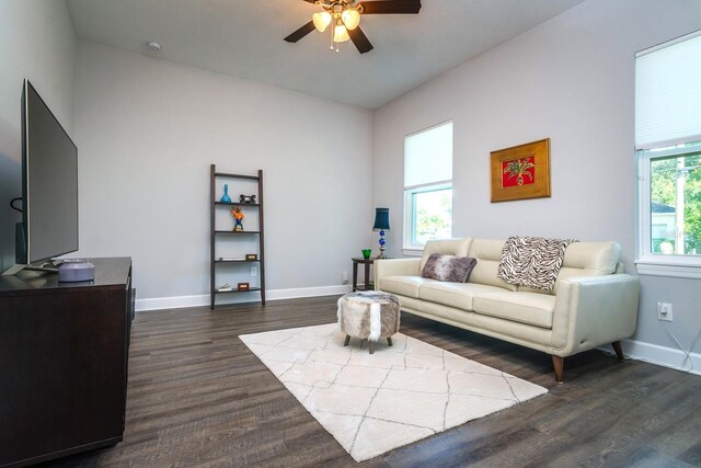 living room with ceiling fan, plenty of natural light, and dark hardwood / wood-style floors