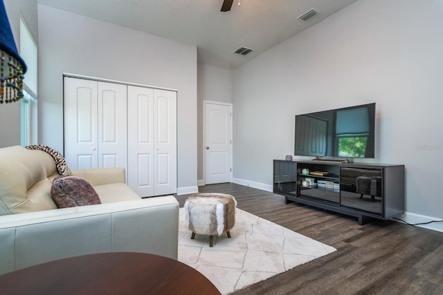 living room featuring plenty of natural light, dark hardwood / wood-style floors, vaulted ceiling, and ceiling fan