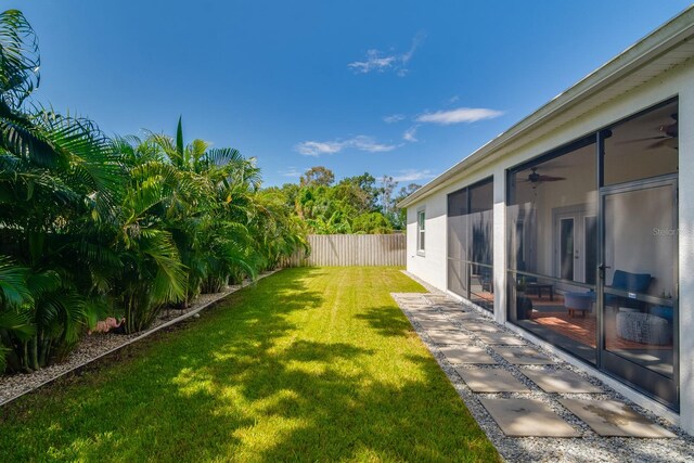 view of yard featuring a patio and ceiling fan