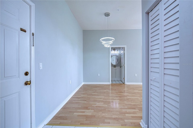 entryway featuring light hardwood / wood-style floors and a notable chandelier