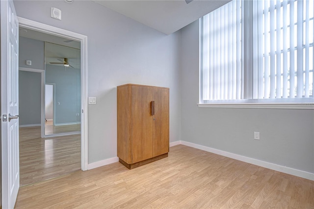 empty room with light wood-type flooring and ceiling fan