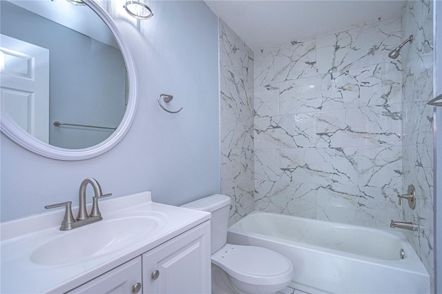 full bathroom featuring tiled shower / bath, vanity, and toilet