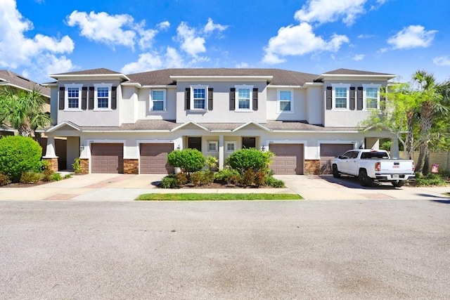 townhome / multi-family property featuring a garage