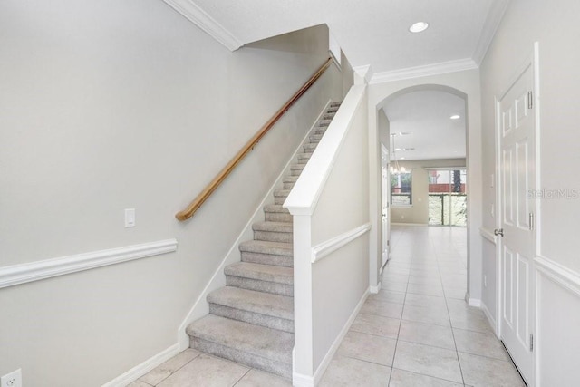 stairway featuring crown molding and tile patterned floors