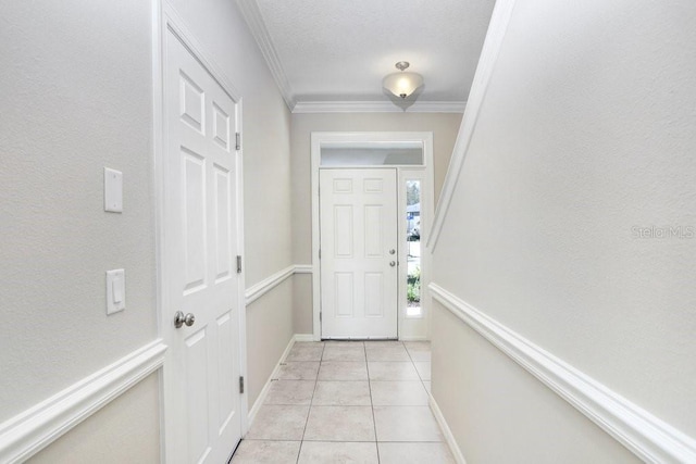 doorway featuring crown molding and light tile patterned flooring