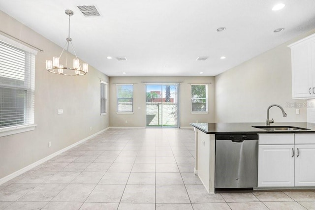 kitchen with stainless steel dishwasher, sink, white cabinets, and decorative light fixtures