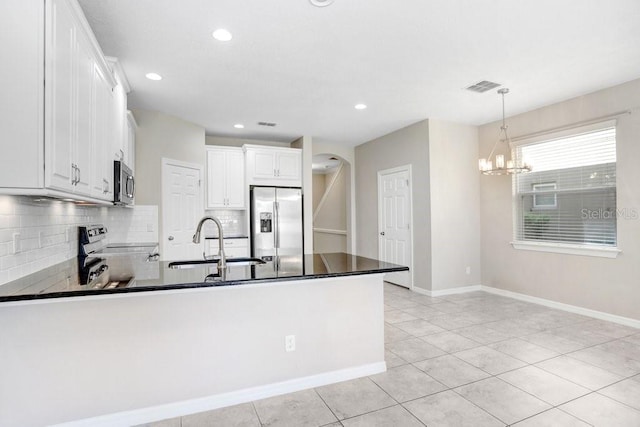 kitchen with sink, white cabinetry, decorative light fixtures, and stainless steel appliances