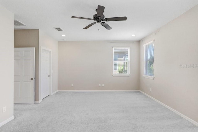 spare room with light carpet and ceiling fan