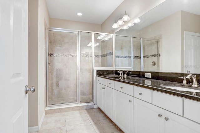 bathroom with vanity, tile patterned floors, and a shower with door