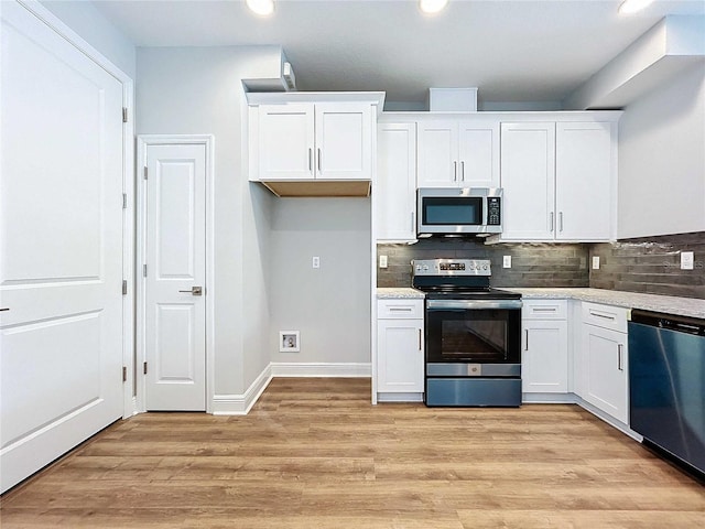 kitchen featuring white cabinets, light hardwood / wood-style floors, and appliances with stainless steel finishes