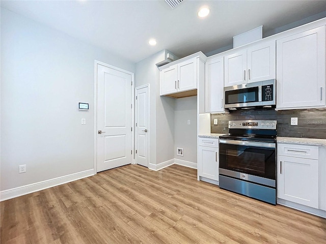 kitchen featuring white cabinets, light wood-type flooring, and appliances with stainless steel finishes