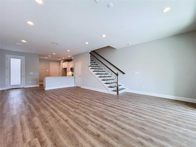 unfurnished living room with light hardwood / wood-style flooring