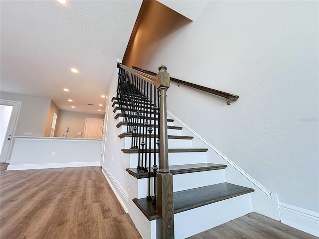 staircase with wood-type flooring