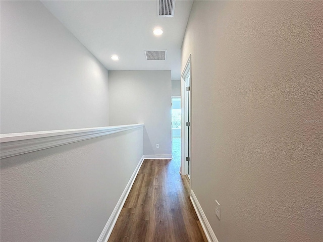 corridor with dark hardwood / wood-style flooring