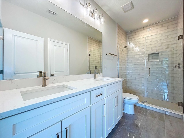 bathroom with vanity, toilet, and a shower with shower door