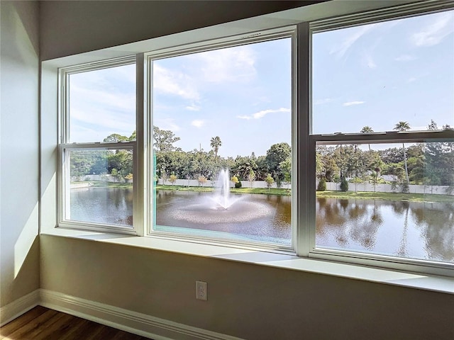 interior space featuring a water view and wood-type flooring