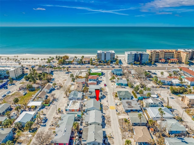 bird's eye view featuring a water view and a beach view