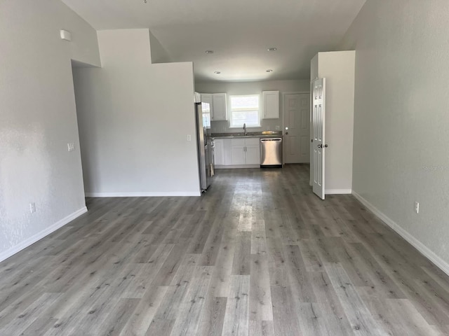 1740 Magnolia Ave, Bartow, FL 33830 - unfurnished living room with light hardwood / wood-style floors and sink