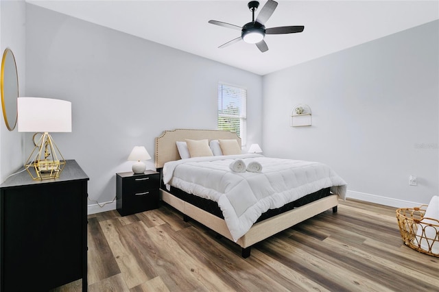 bedroom with ceiling fan and dark hardwood / wood-style flooring