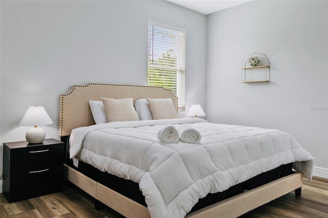 bedroom featuring dark hardwood / wood-style flooring