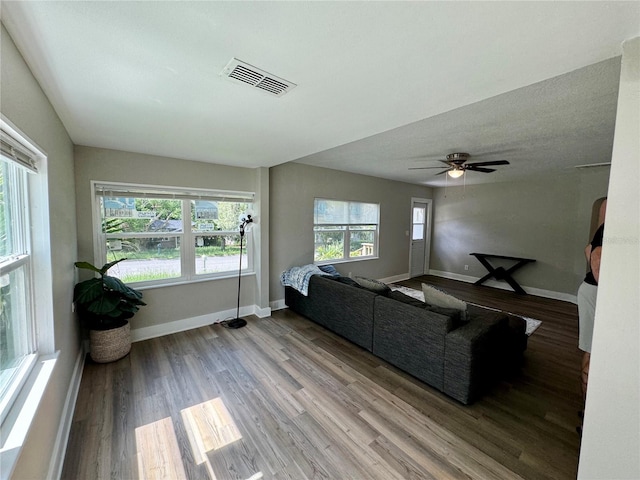 living room featuring ceiling fan and light wood-type flooring