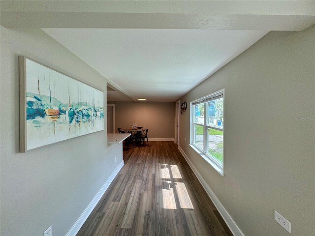 hallway with hardwood / wood-style floors