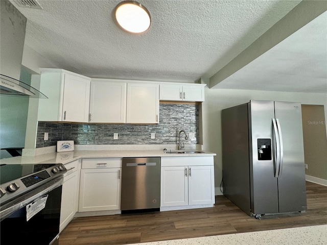 kitchen with dark wood-type flooring, appliances with stainless steel finishes, and white cabinets