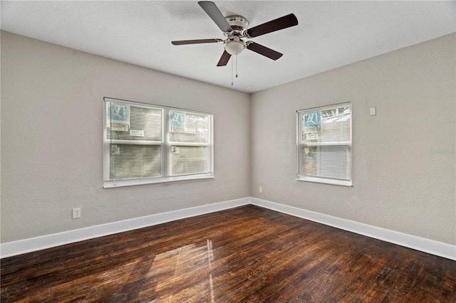 empty room featuring dark hardwood / wood-style floors and ceiling fan