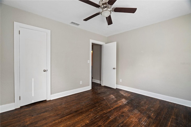 unfurnished room featuring dark hardwood / wood-style floors and ceiling fan