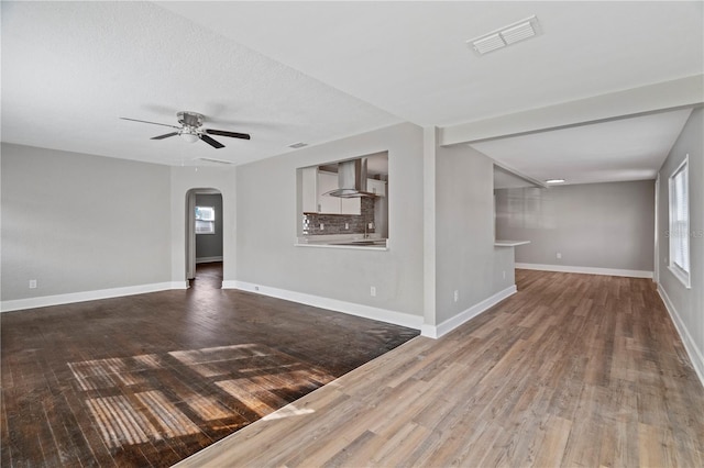 empty room featuring ceiling fan, a textured ceiling, and hardwood / wood-style floors