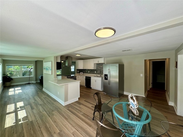 kitchen with dishwasher, kitchen peninsula, stainless steel fridge with ice dispenser, light wood-type flooring, and white cabinets