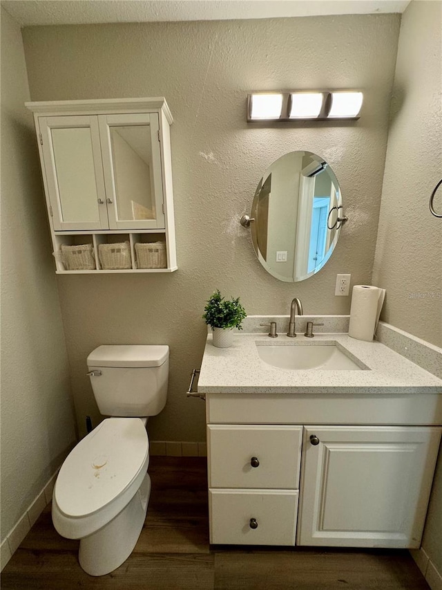 bathroom featuring vanity, toilet, and wood-type flooring