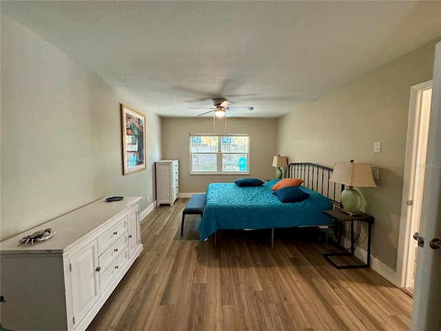 bedroom featuring hardwood / wood-style floors and ceiling fan