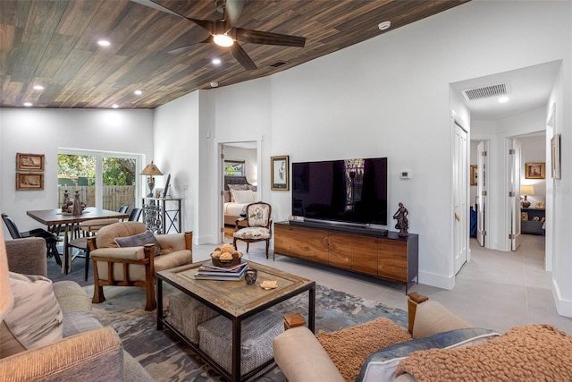 tiled living room featuring wood ceiling, high vaulted ceiling, and ceiling fan