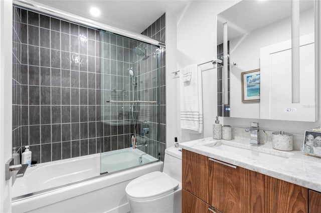 full bathroom with vanity, toilet, and shower / bath combination with glass door