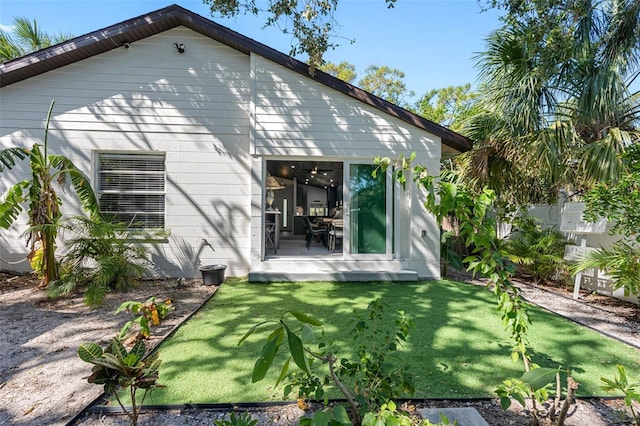 rear view of property with a lawn