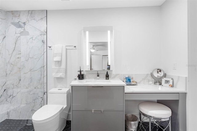 bathroom with vanity, a tile shower, toilet, and ceiling fan