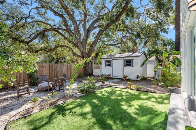 view of yard with a storage unit, an outdoor fire pit, and a patio