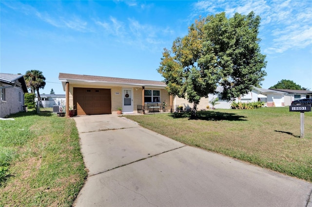 ranch-style home featuring a front lawn, an attached garage, fence, and concrete driveway