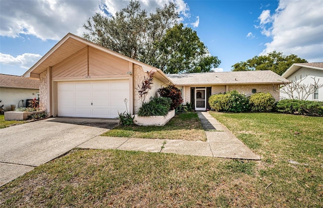 view of front of property featuring a garage, concrete driveway, a front lawn, and stucco siding