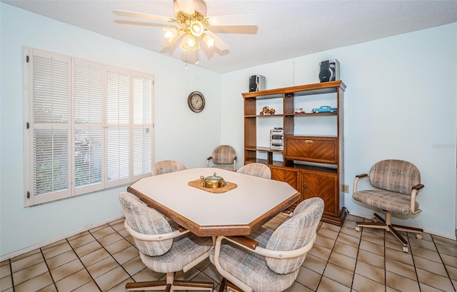 dining room with light tile patterned flooring, a ceiling fan, and a textured ceiling