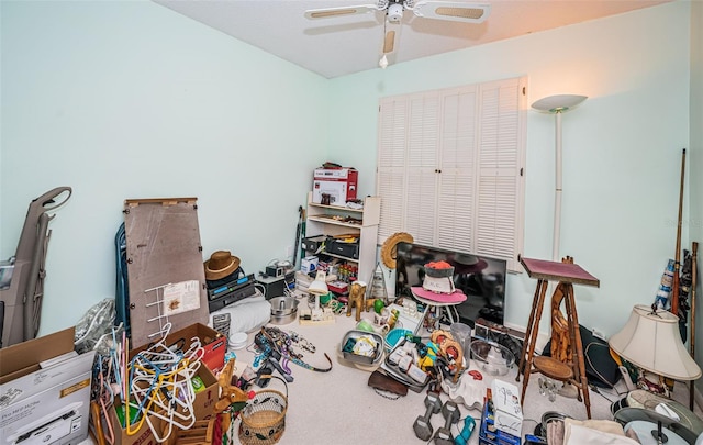 interior space with ceiling fan