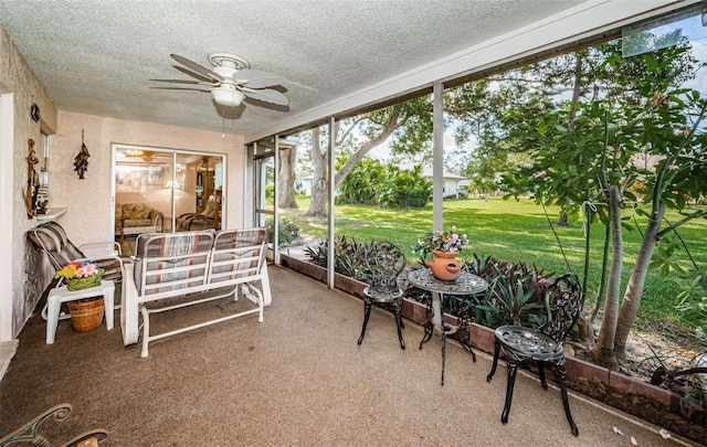 sunroom featuring ceiling fan