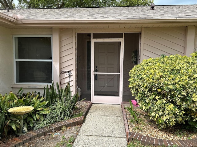 property entrance with roof with shingles