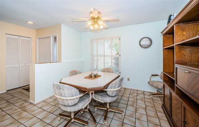 dining area featuring ceiling fan, baseboards, a textured ceiling, and light tile patterned flooring